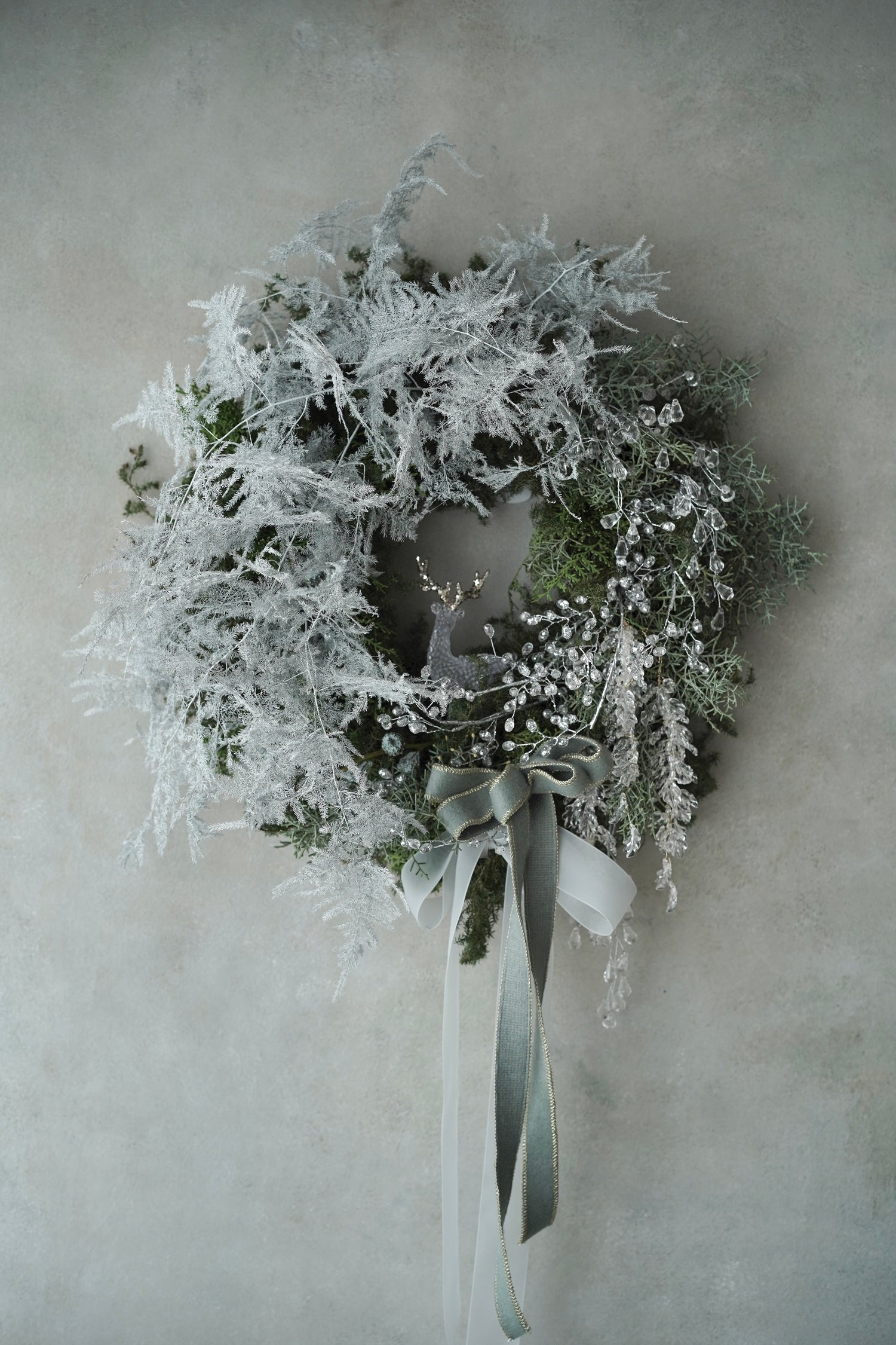 Serene white Winter Bliss Wreath with frosted greenery and delicate deer ornament